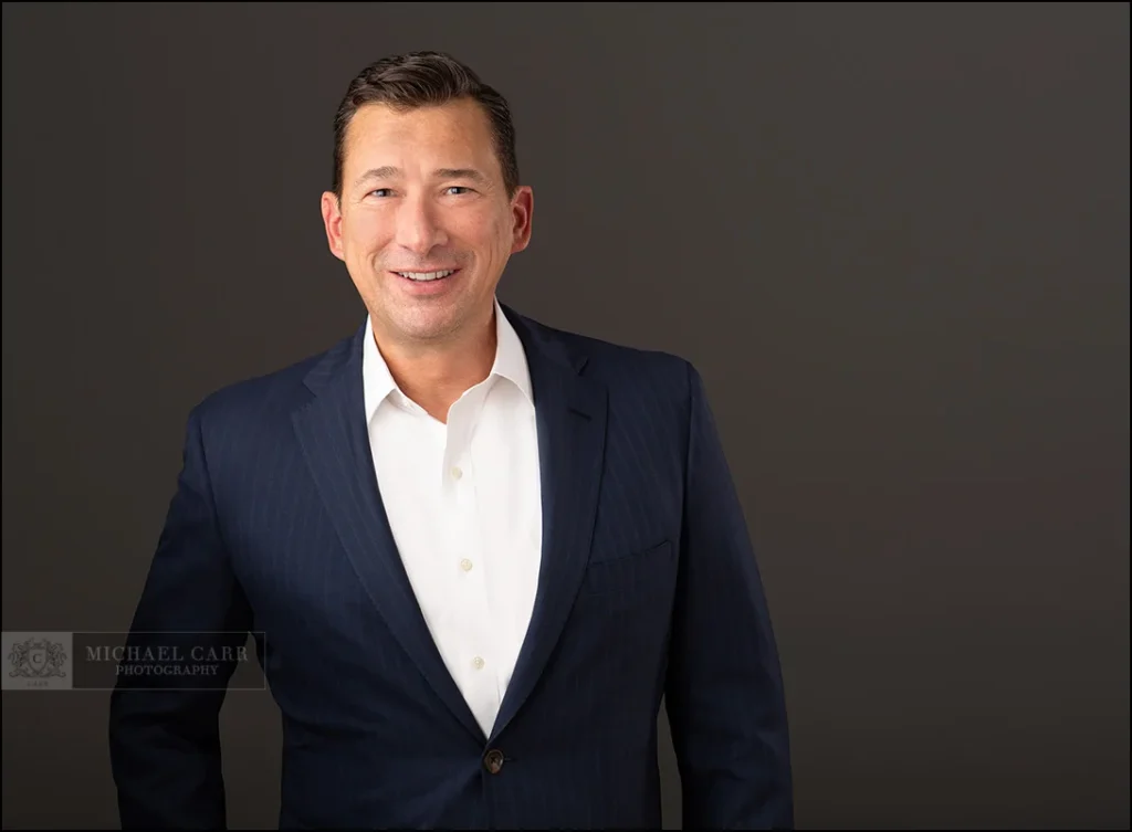 Personal Branding Photographer Professional portrait of a businessman in a blue suit during a Houston business headshot session.