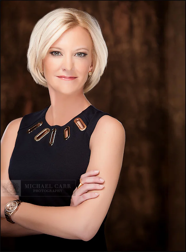 Personal Branding Photographer Confident businesswoman with folded arms photographed by Houston Headshot Photographers.