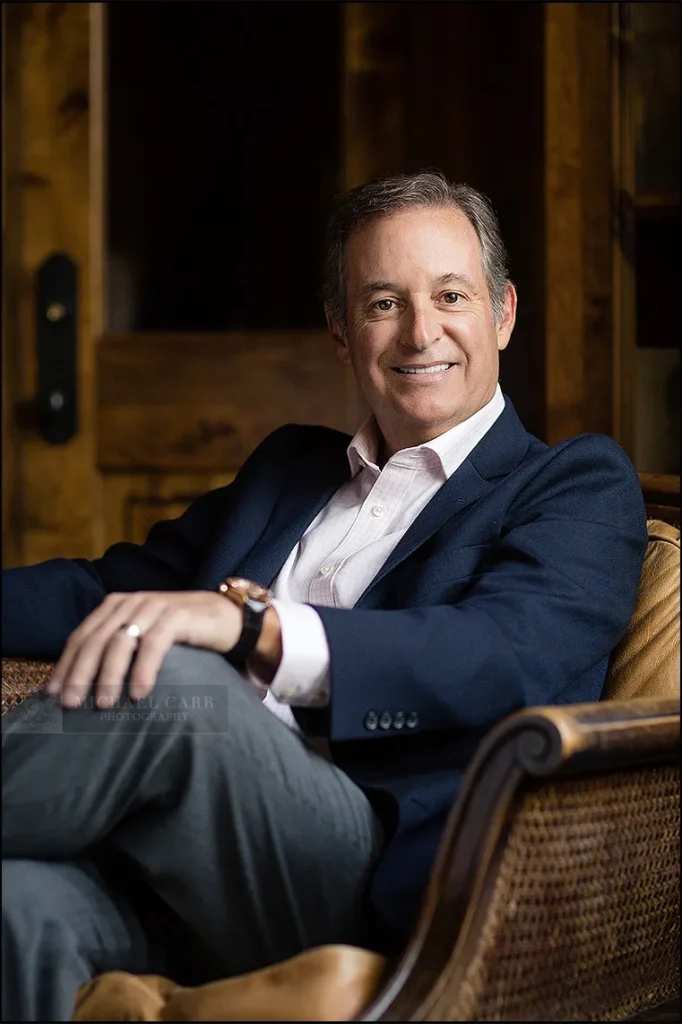 Executive seated in a leather chair during a Houston personal branding photography session.