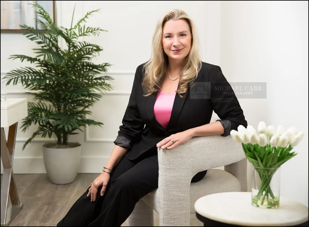Houston attorney branding portrait in a modern office with a professional seated pose.