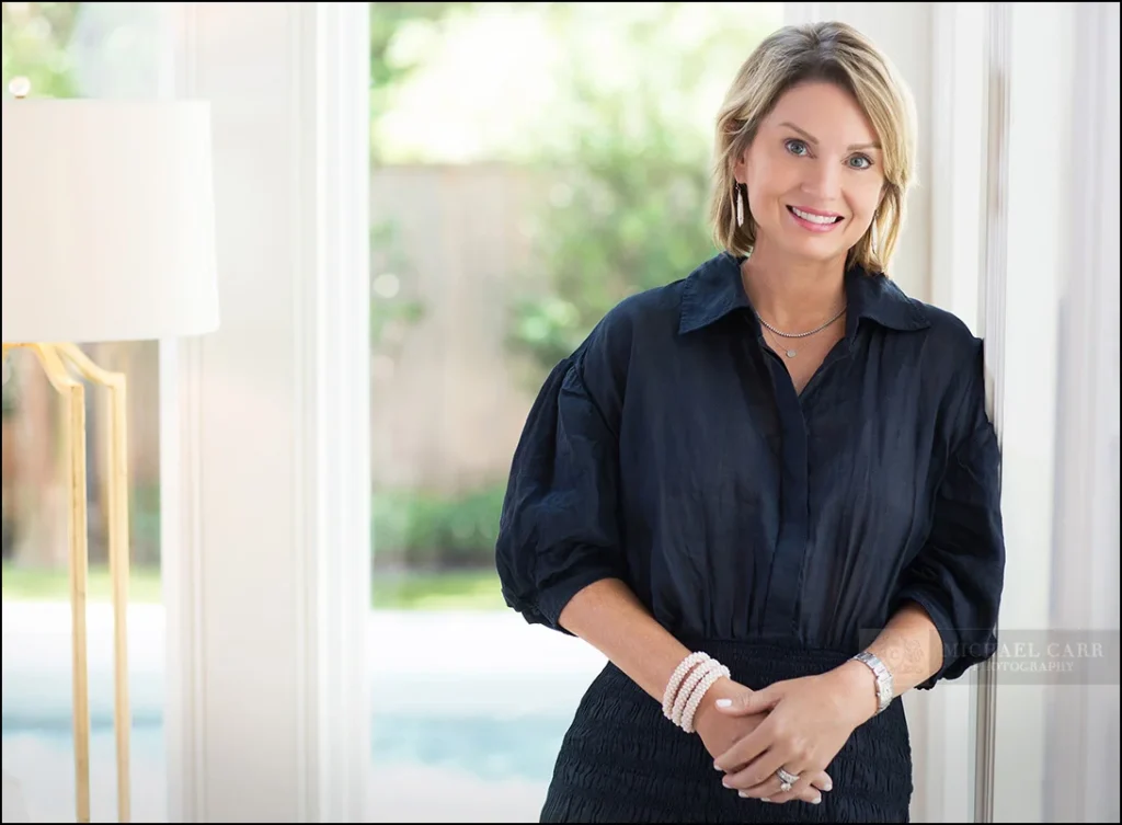 Personal branding portrait of a Houston book author in a modern home office with natural light.