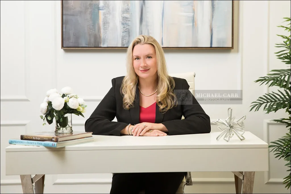 Professional branding portrait of an attorney seated at custom set office desk in Houston.