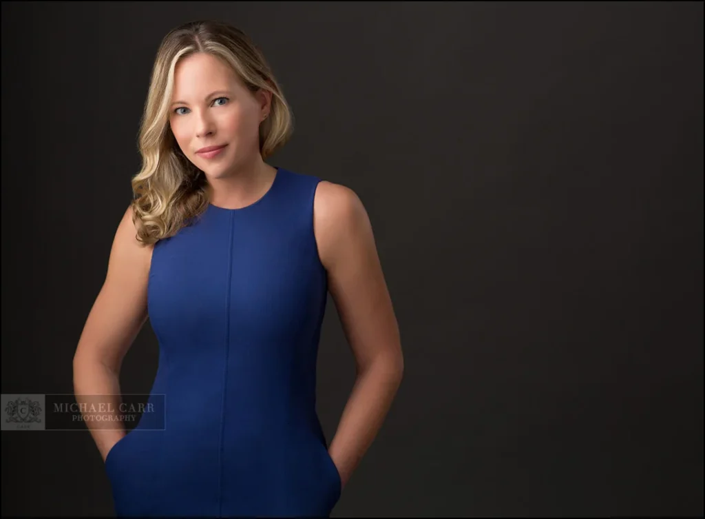 Personal Branding Photographer Professional portrait of a woman in a blue dress during a Houston headshot photography session.